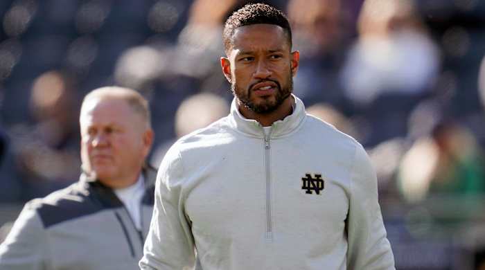 FILE - Notre Dame defensive coordinator Marcus Freeman watches during warmups before an NCAA college football game against Navy in South Bend, Ind., Saturday, Nov. 6, 2021. Notre Dame has completed a whirlwind coaching search that never seriously left campus, promoting defensive coordinator Marcus Freeman to coach of the Fighting Irish on Friday, Dec. 3, 2021. Freeman, 35, takes over less than a week after Brian Kelly’s surprising departure for LSU with the Irish still in contention for the College Football Playoff.